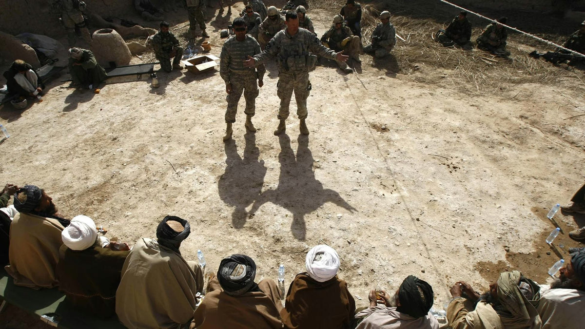 U.S. and Afghan personnel meeting with local Afghan village elders during a security discussion in rural Afghanistan amid the U.S. war effort